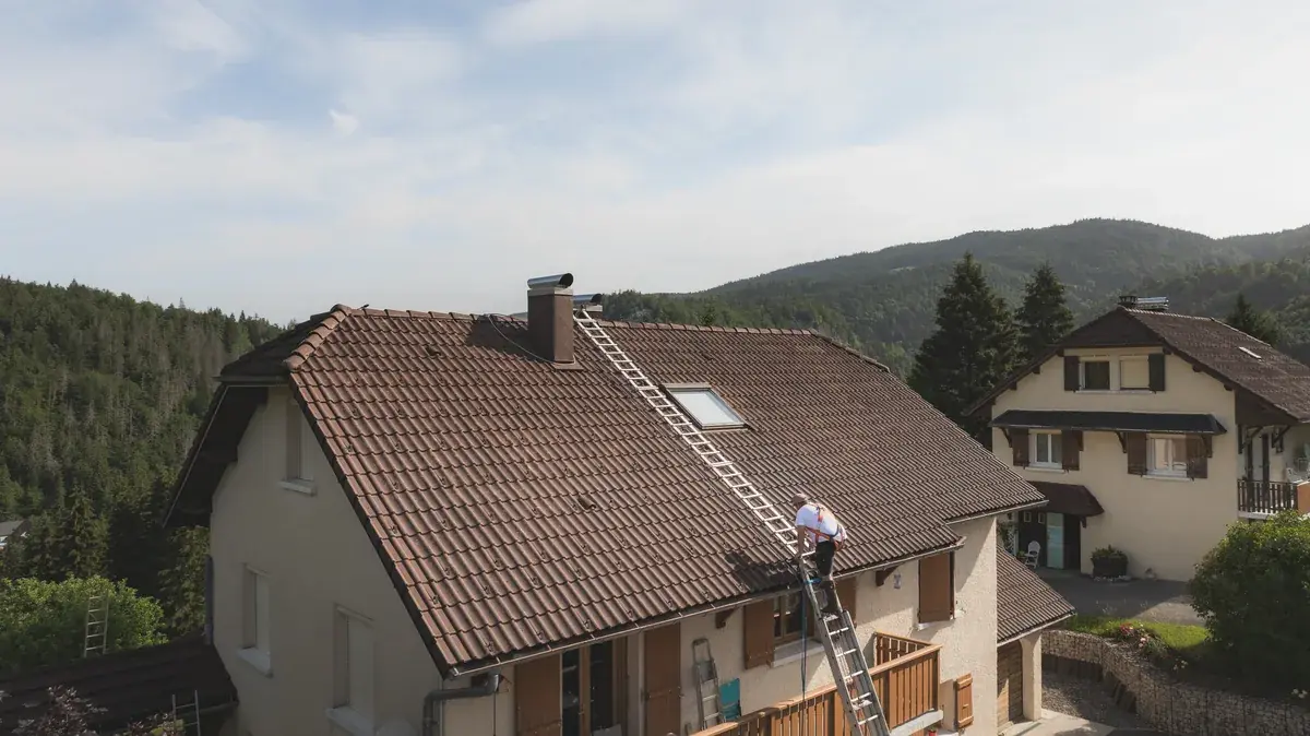 Vue aérienne d’une toiture en tuiles rénovée, chantier dans le Jura